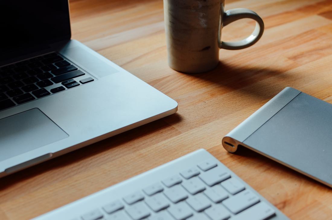 A laptop and a mug on a desk